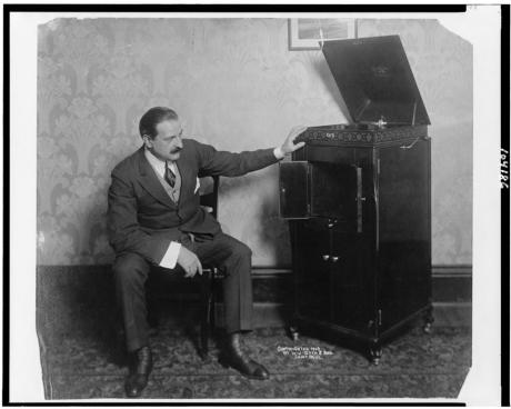 Man seated alongside phonograph, c. 1909. Library of Congress.